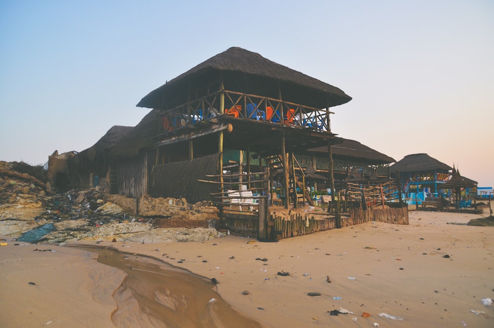 gray 2-story hut on seashore