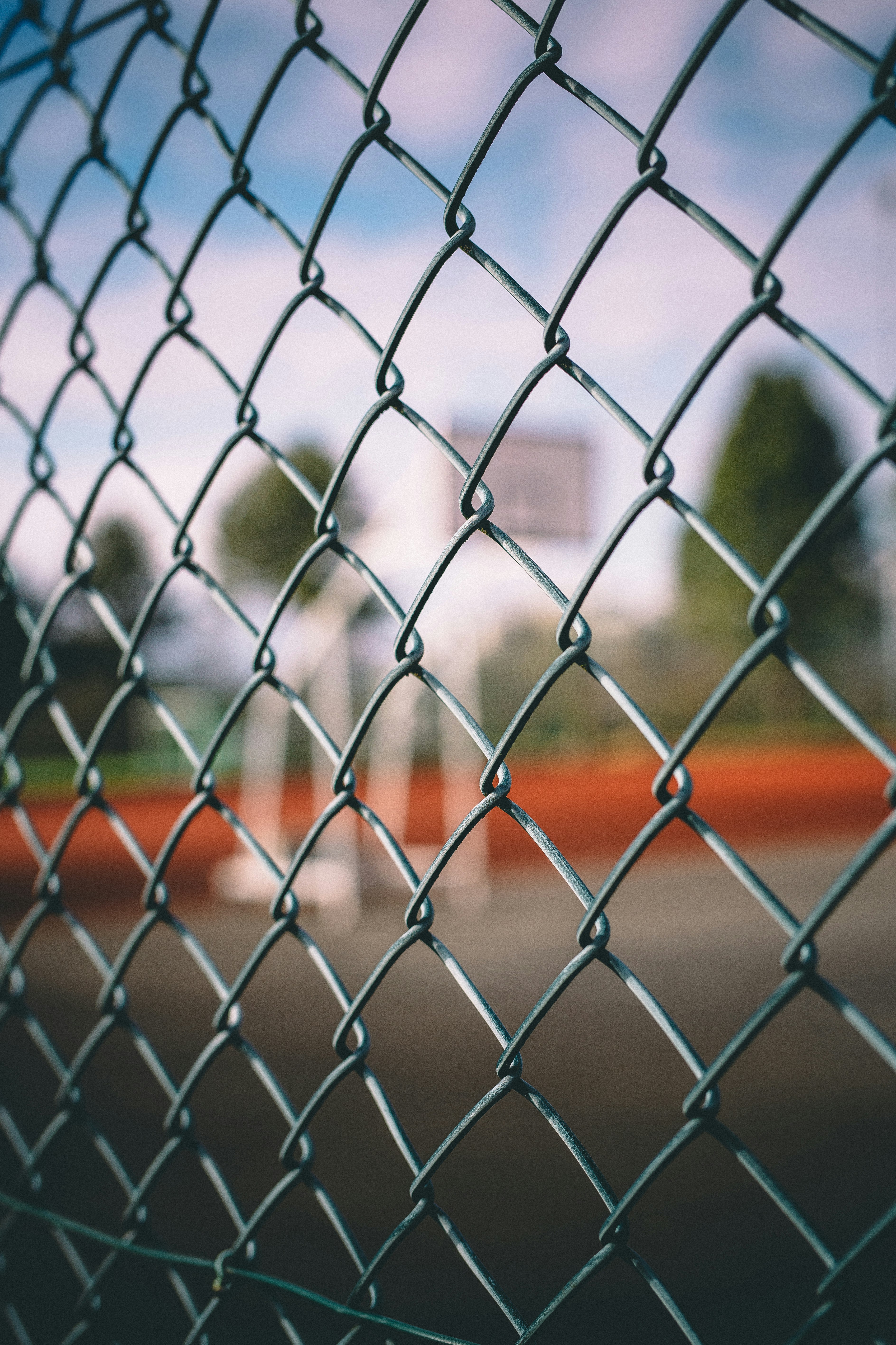 shallow focus photography of silver cyclone fence