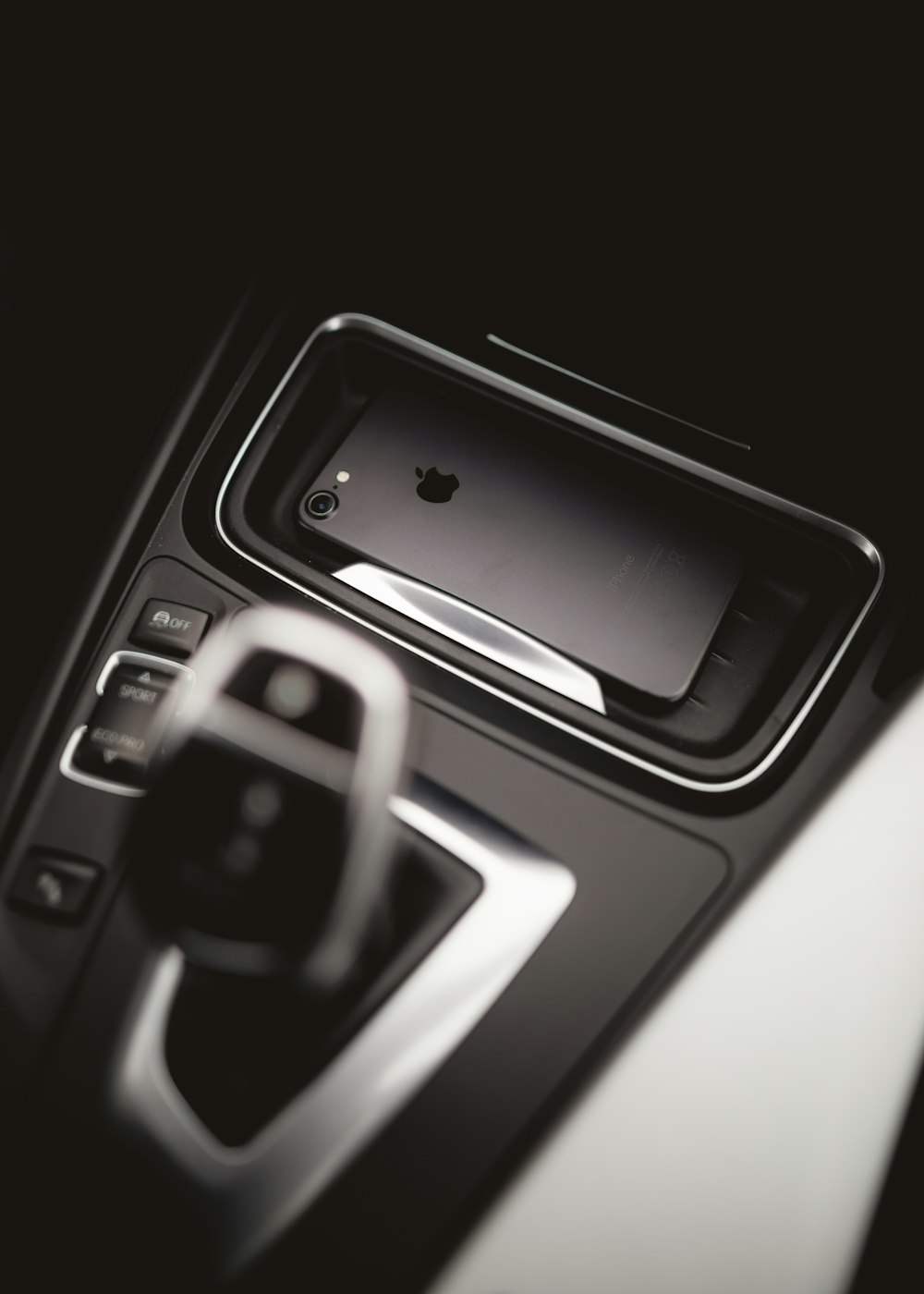 space gray iPhone 7 beside gear shift lever