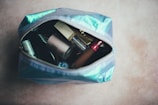 assorted cosmetic products on blue bag