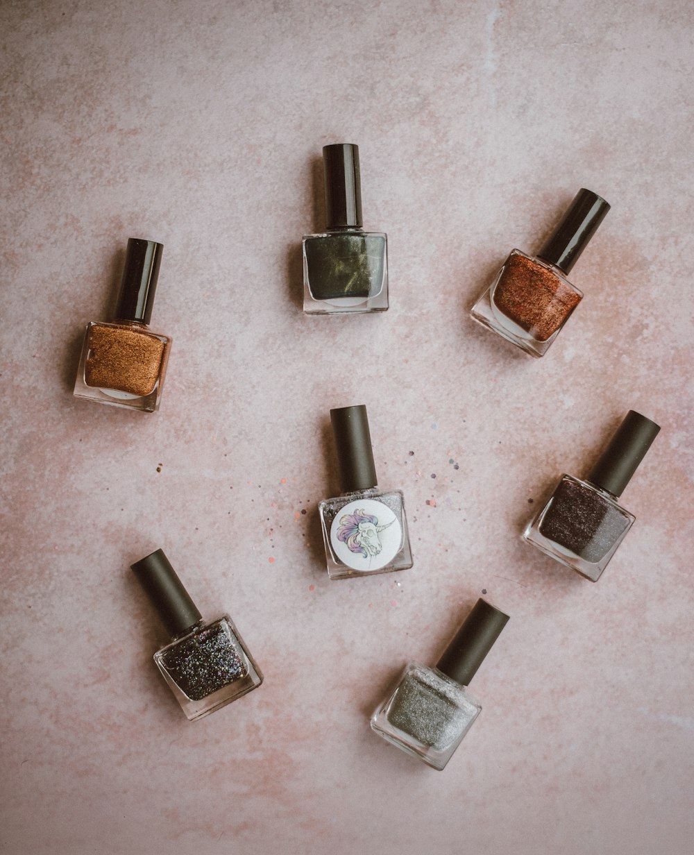 brown, black, and grey nail polish bottles