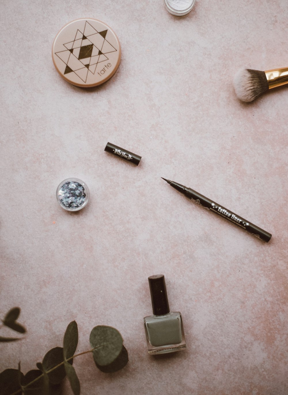 assorted makeup on beige surface