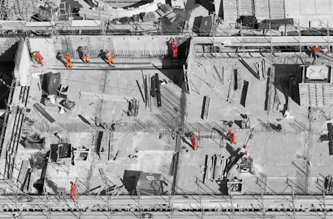 Image of construction workers building the base of a building