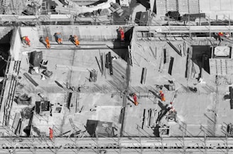 selective color photo of man on top of gray building