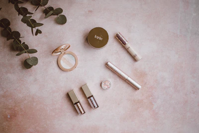 Brightly colored cosmetic products arranged on a clean white surface