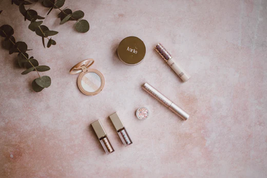 Gold lipstick cases arranged on a pale grey surface
