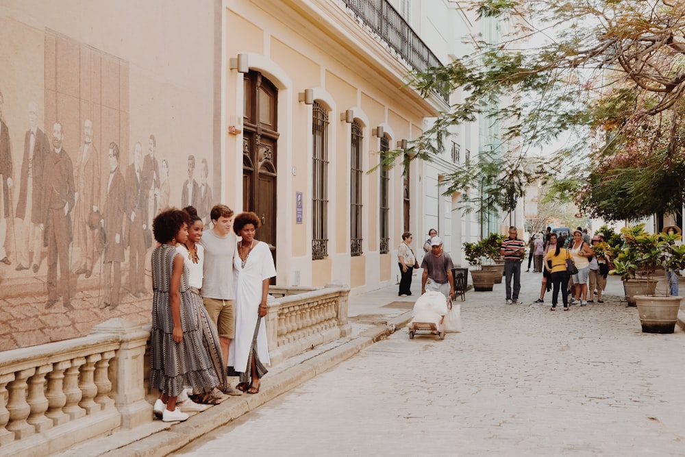 group of people standing near wall