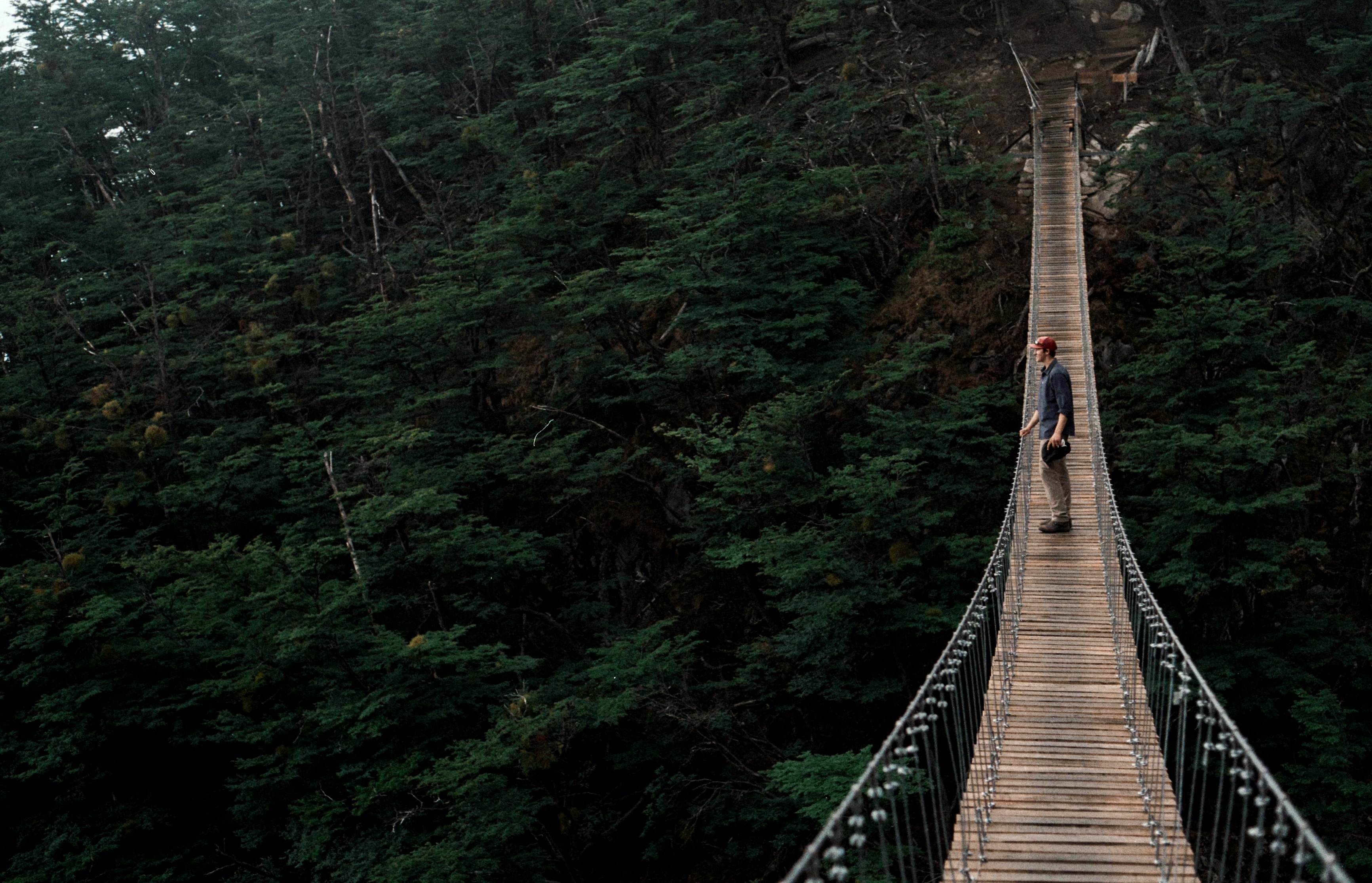 man standing on the middle of the bridge outdoor