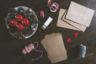 Close-up of hands arranging festive ribbons and party favors on a table.