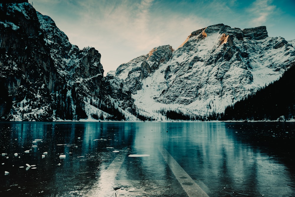 body of water near snow mountain