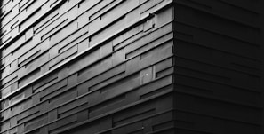 A close-up of a modern building material sample with textures in muted tones.