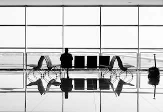 man sitting on gang chair during daytime