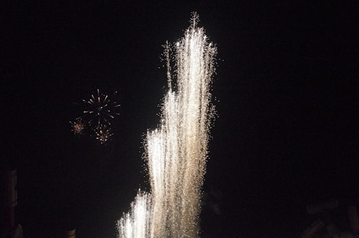 Explosions and fireworks lighting up the Minecraft night sky in a PvP tournament.