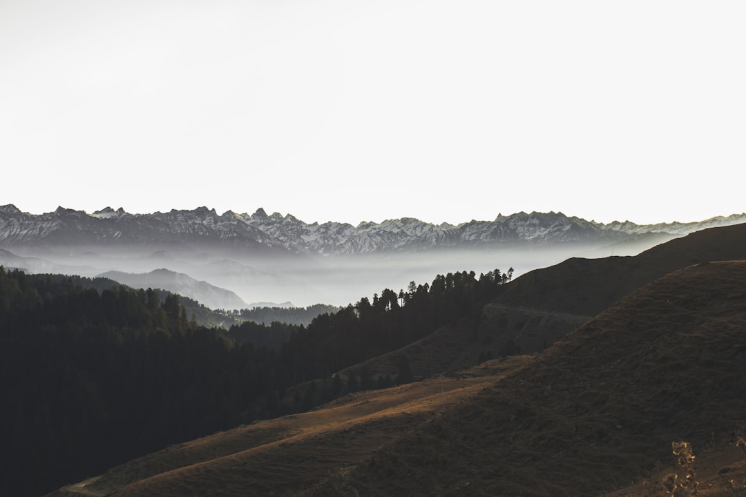 mountain rage view under cloudy sky during daytime