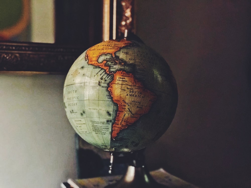 selective focus photo of desk globe