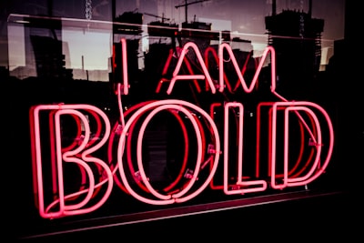 i am bold neon signage at night time bold zoom background