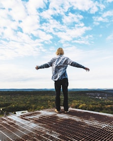 a man standing on top of a metal structure