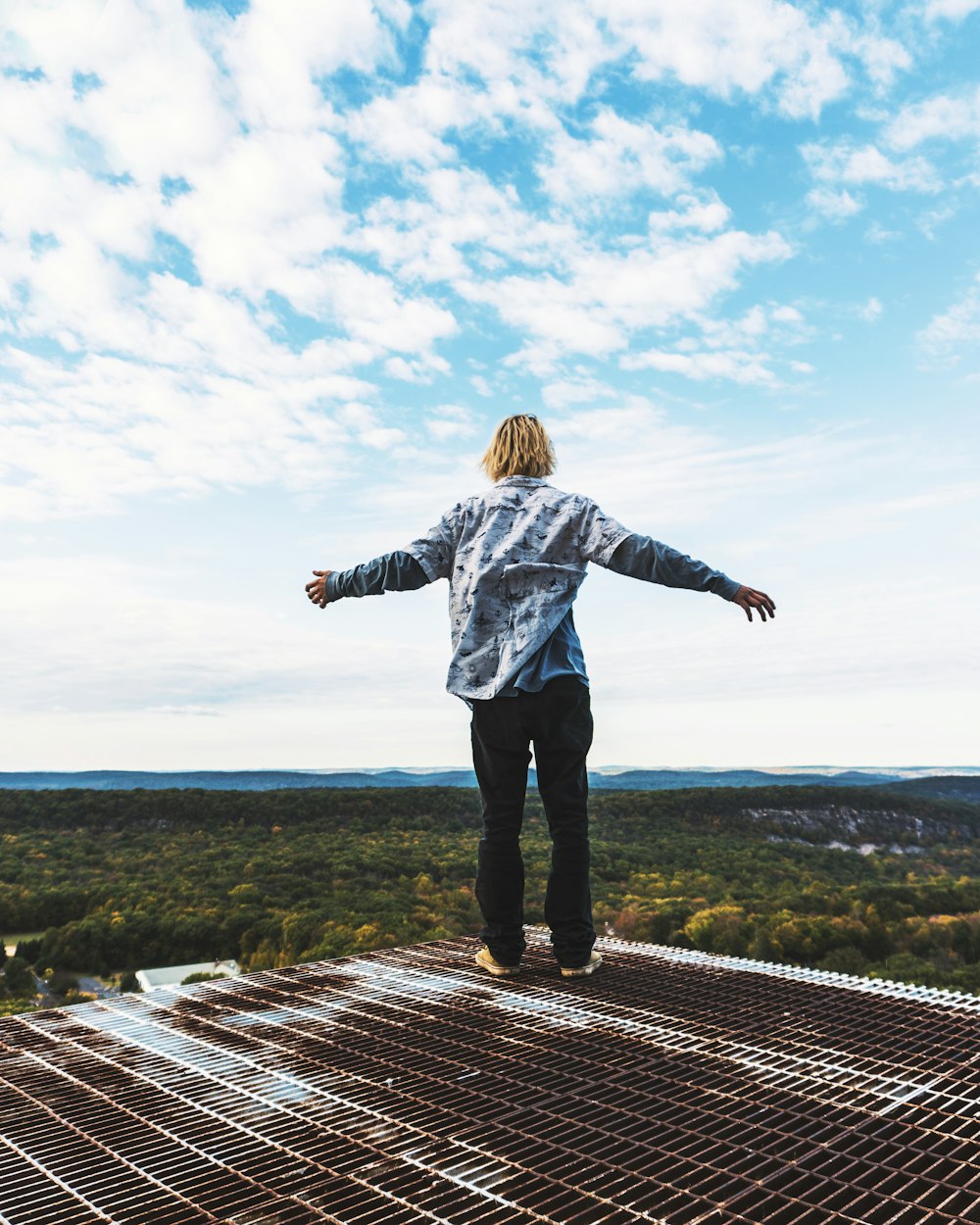 a man standing on top of a metal structure