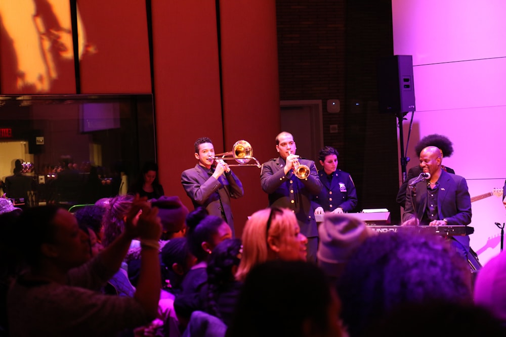 group of men playing music instruments on stage