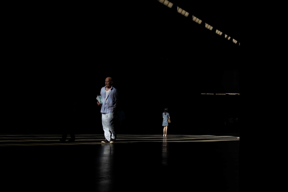 person standing on platform in dark area