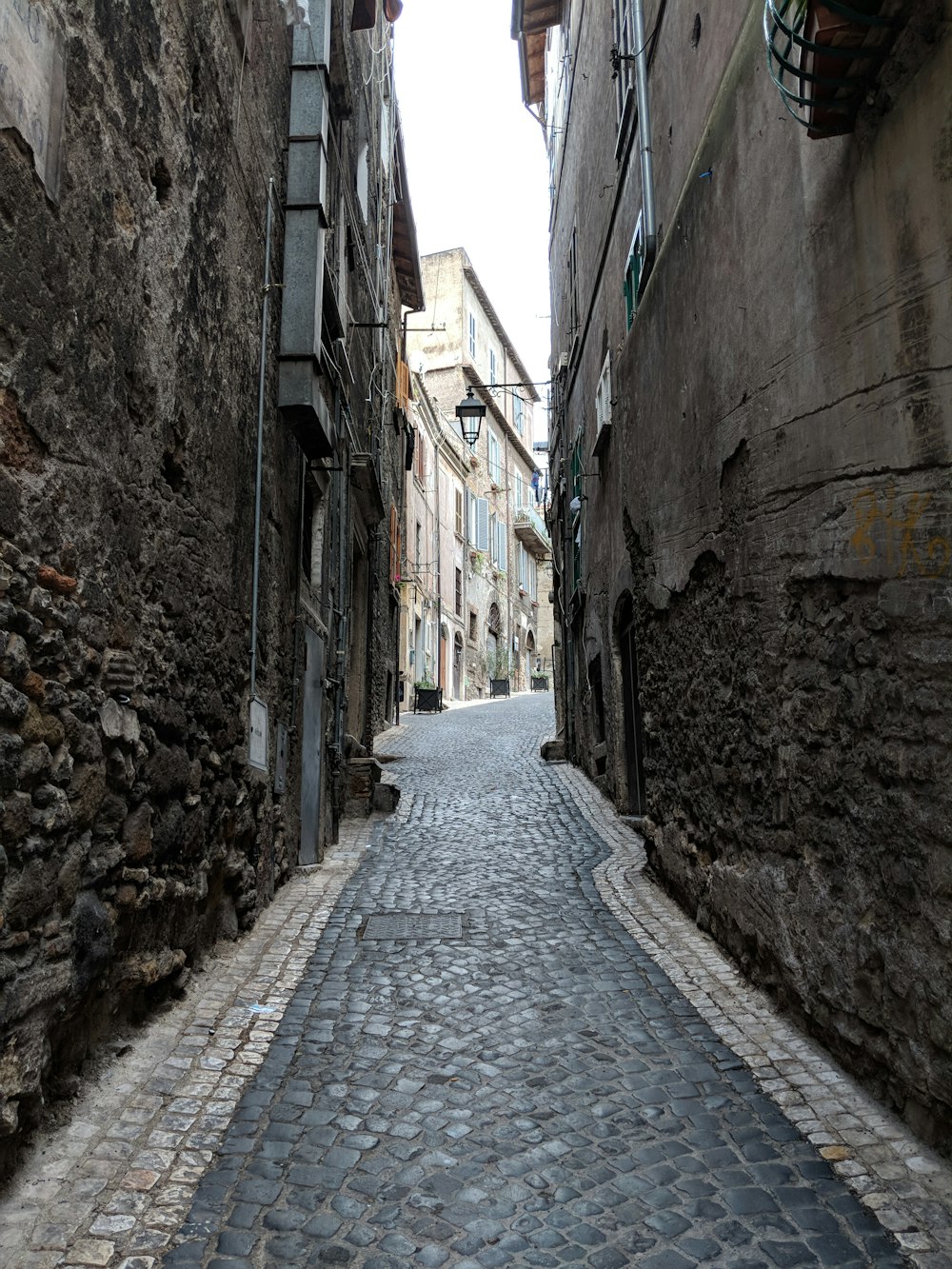 black bricked pavement between buildings