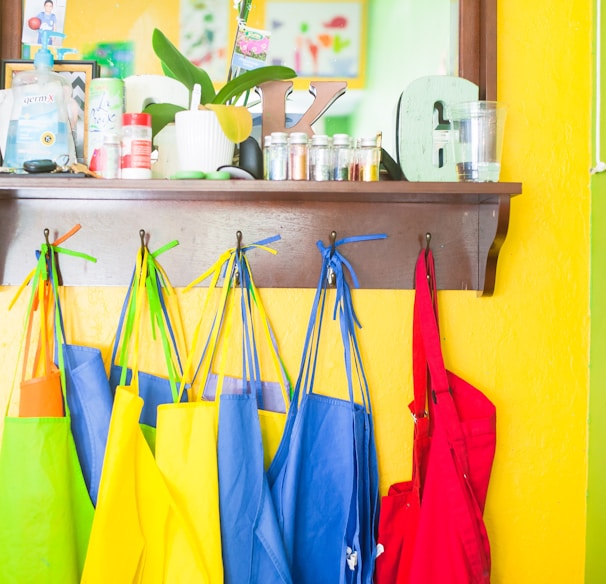 assorted-color bag lot hanging on brown wooden wall rack