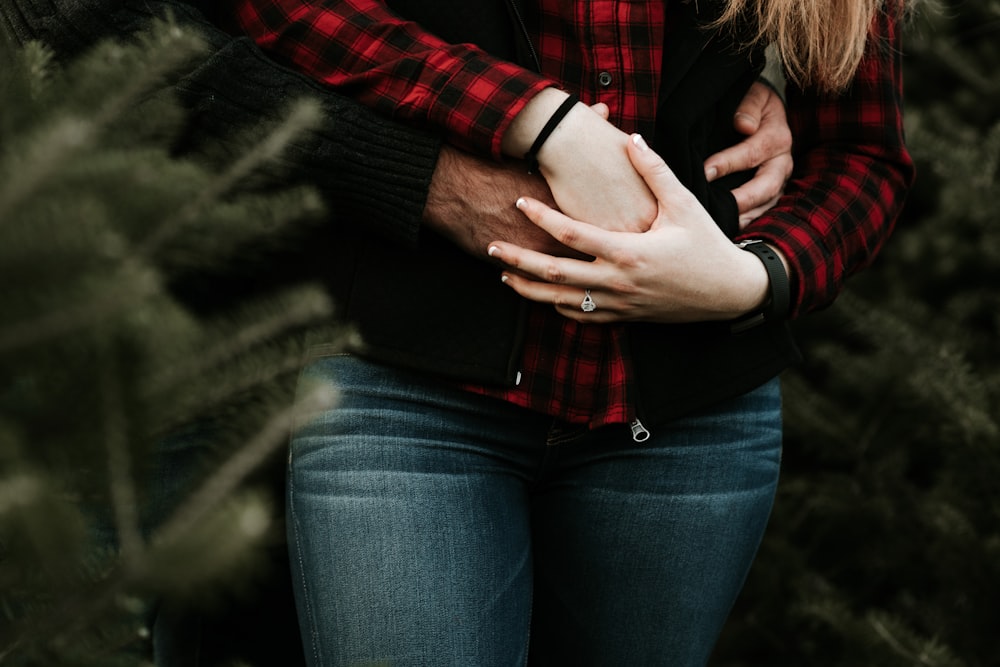 man hugging woman from behind