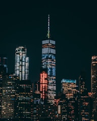 high-rise buildings with lights on under black sky during night time