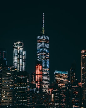 high-rise buildings with lights on under black sky during night time