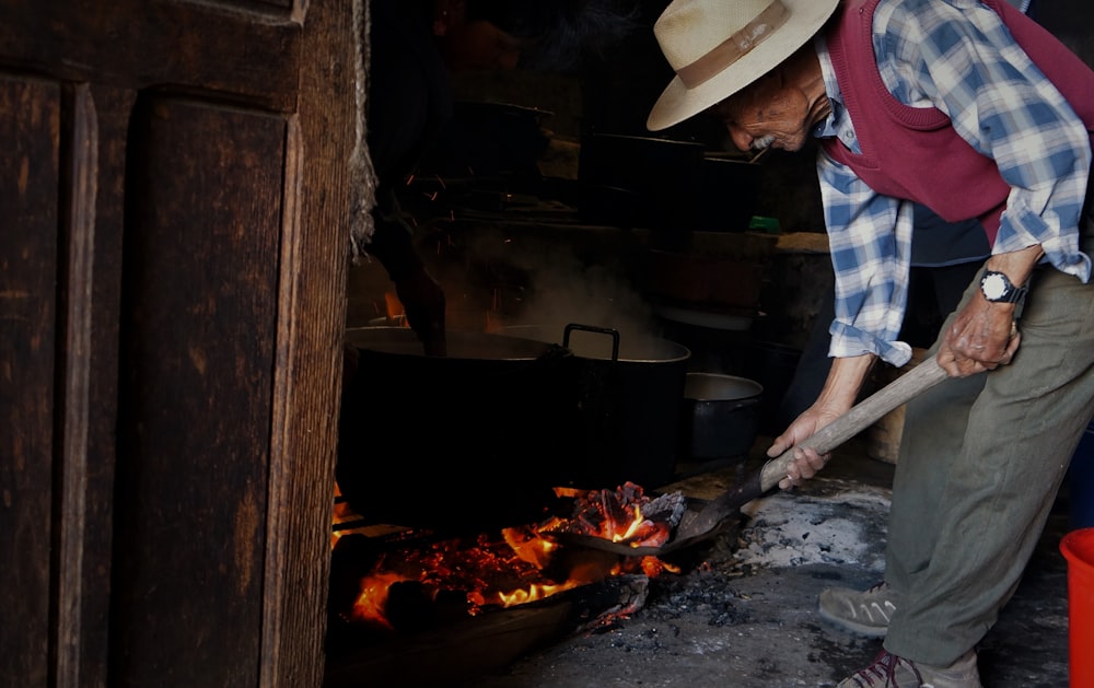 man cooking on pot