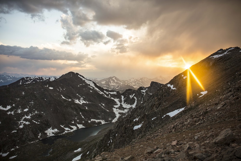 mountain near road and body of water