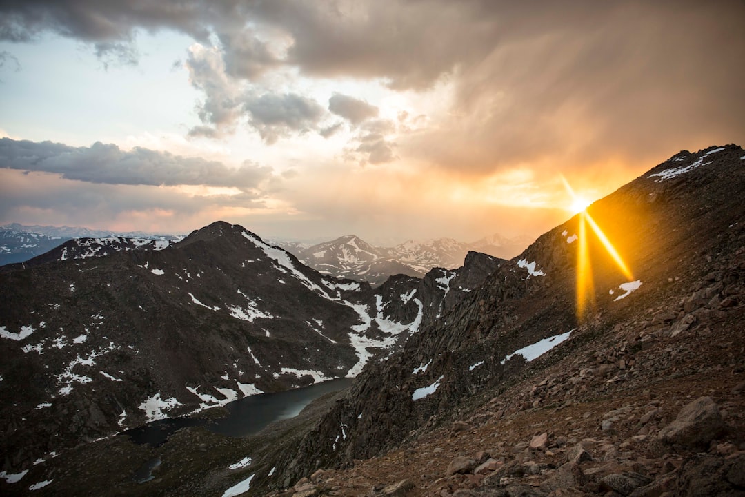 mountain near road and body of water