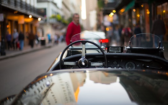 black convertible in front of standing man during daytime in French Quarter United States