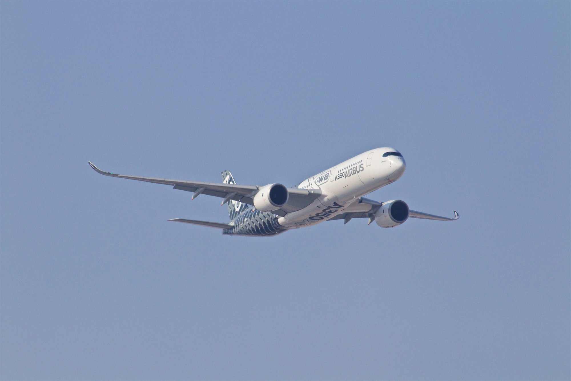 white airplane taking off during daytime