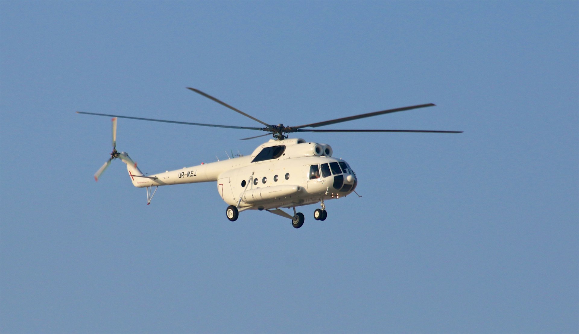 white helicopter under blue sky during daytime