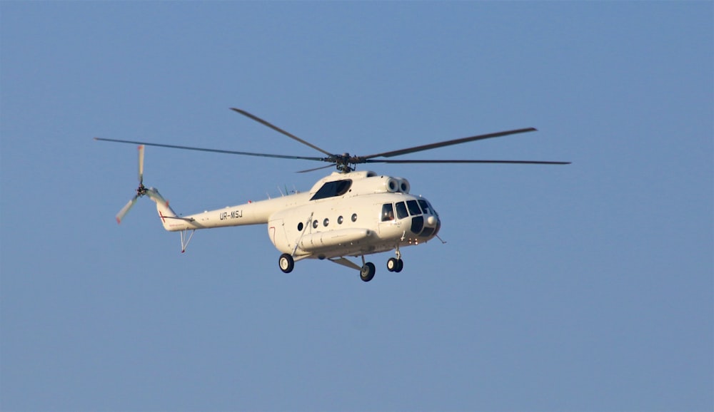 white helicopter under blue sky during daytime