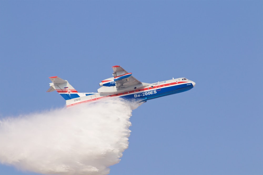 white and blue airplane on blue sky