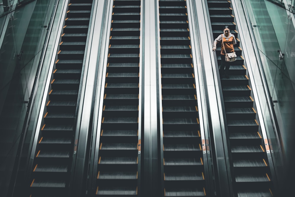 woman standing on the escalator