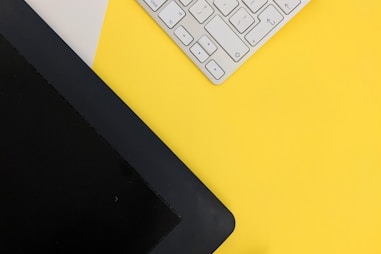 gray Apple wireless keyboard beside black tablet computer and stylus pen