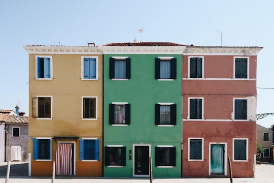 brown, green, and red houses in Burano Italy