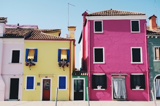 yellow and pink concrete houses during daytime