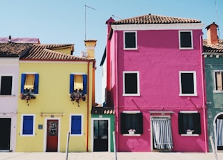 yellow and pink concrete houses during daytime