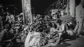 Technicians handling vehicle paperwork at a recycling center.