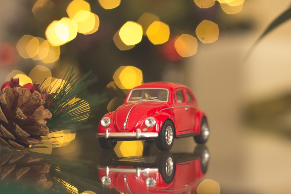 red Volkswagen car die-cast model on table