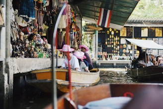 A vibrant group of travelers enjoying a guided tour in a bustling Southeast Asian market.