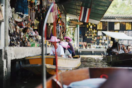 A group of happy tourists enjoying a scenic guided tour in a vibrant local market.