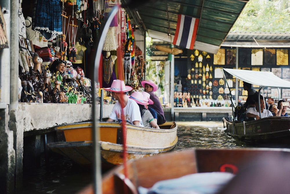 group of people riding wooden boat on water