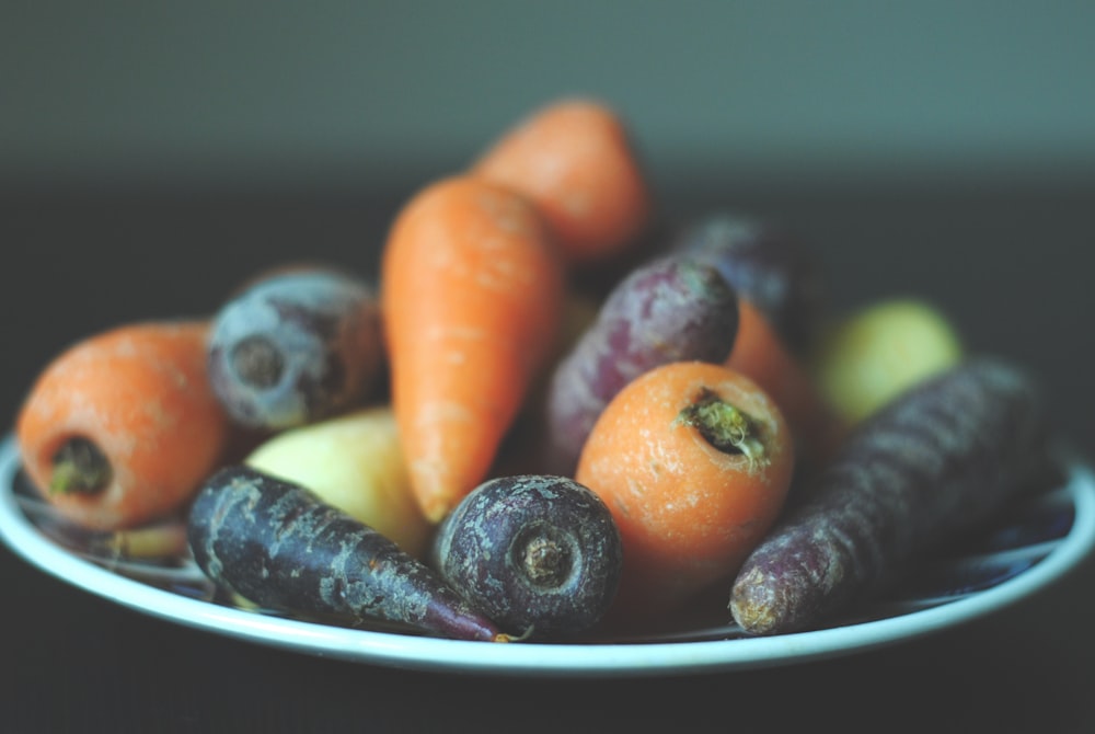 bunch of carrots on white plate