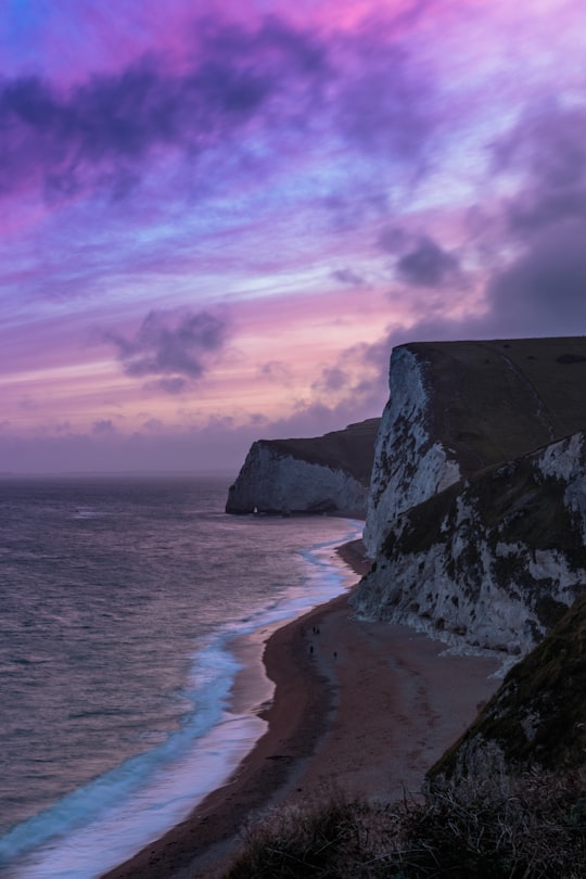 brown and gray rock formation near sea in Durdle Door United Kingdom