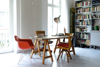 photography of brown wooden dining set near window